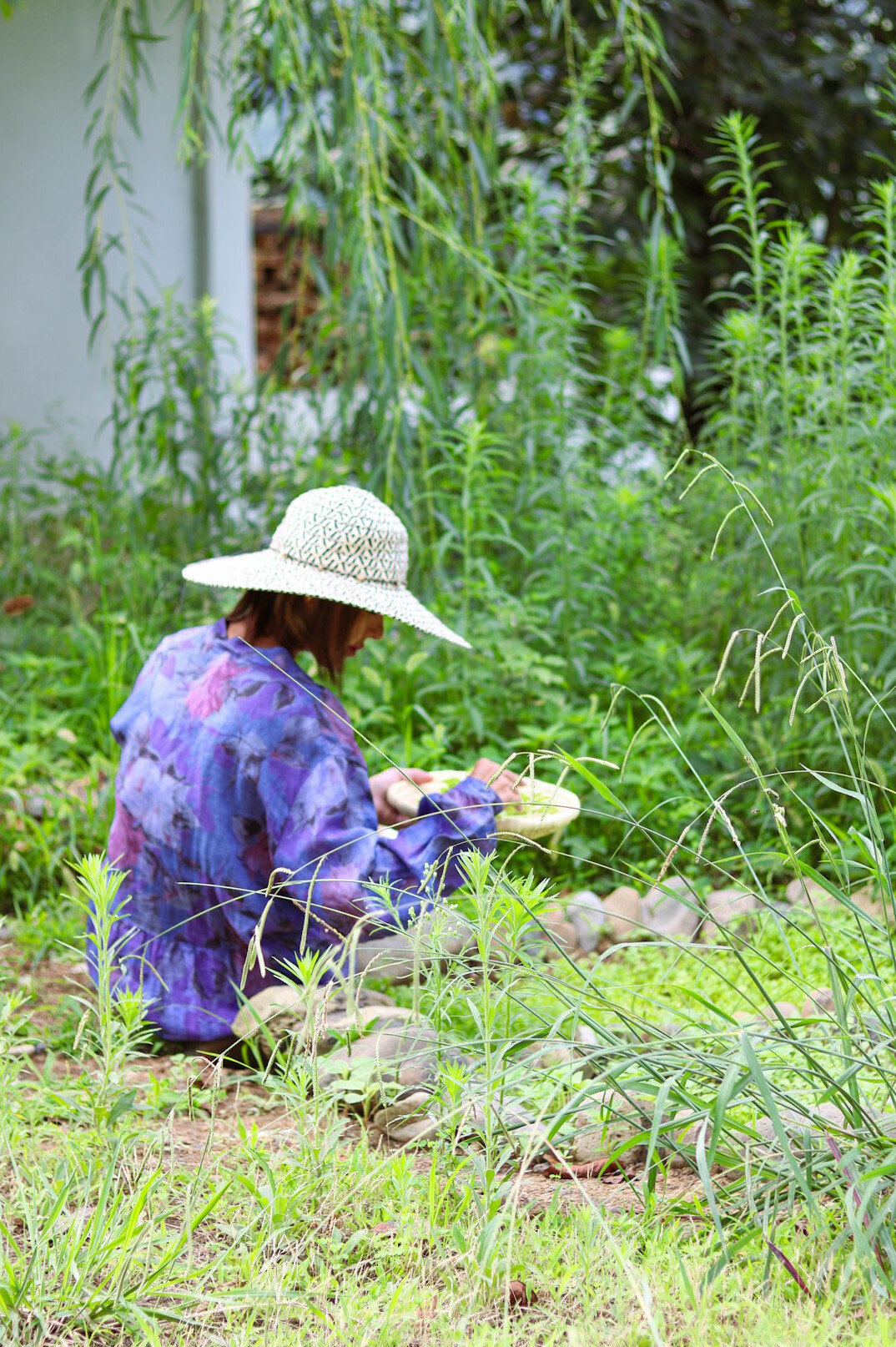 elderly woman reading in garden